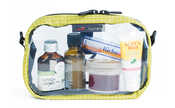 A Wasabi green with white grid pattern (Halcyon) 3D Clear Organizer Cube filled with sundries.